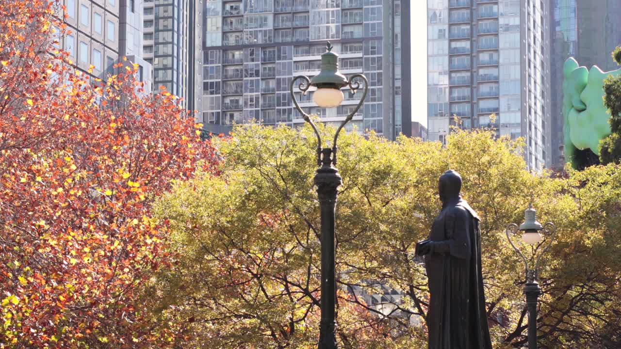 멜버른에 있는 건물과 나무들 가운데 있는 동상