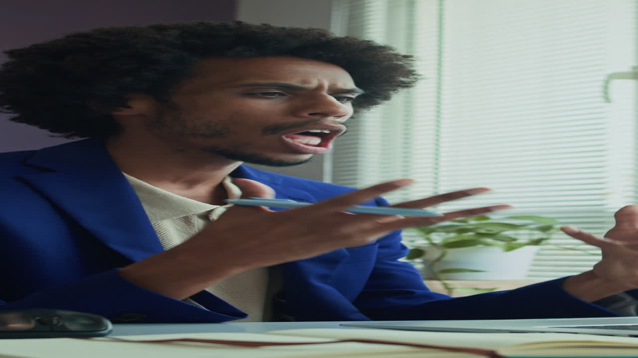 Male Solopreneur Talking during Video Call on Laptop