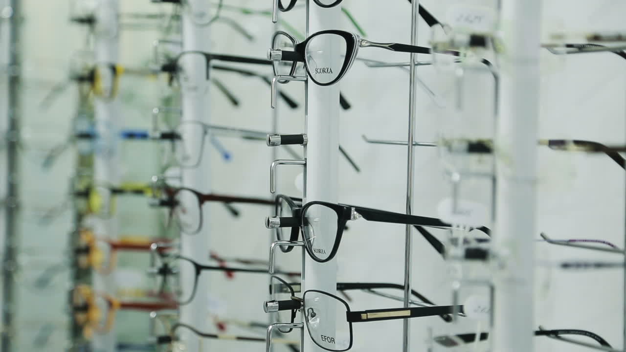 Woman choosing eyeglasses. Woman looking at display and choosing new glasses in optical shop