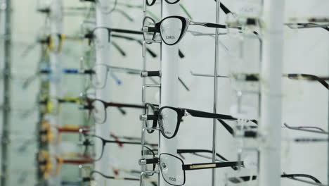 woman choosing eyeglasses. woman looking at display and choosing new glasses in optical shop
