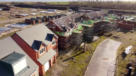 rising aerial view over unfinished waterfront townhouse neighbourhood development construction site