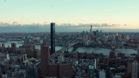 Landing-footage-of-various-tall-buildings-in-city.-Large-cable-stayed-bridge-in-background.-Manhattan,-New-York-City,-USA