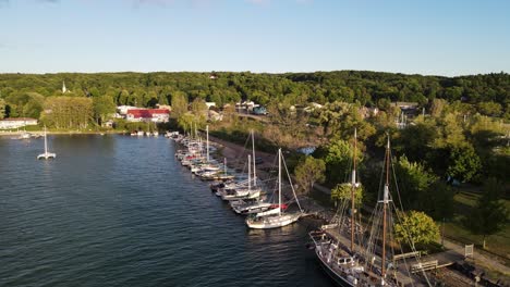 suttons bay with moored boats in michigan, usa, aerial drone ascend view