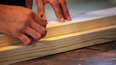 carpenter marking wood pieces