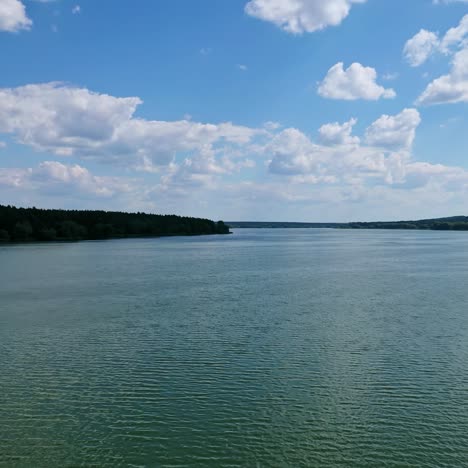 evening water under blue sky. beautiful wide river landscape. calm river among fields and forests. aerial flight.