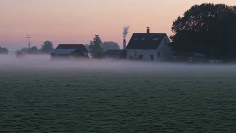 misty sunrise over a farm