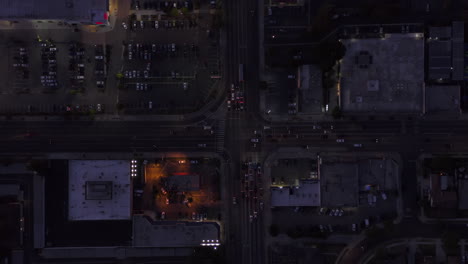 Top-View-of-City-Road-Intersection-after-Sunset-at-Dusk,-Scenic-Aerial-Birds-Eye-Overhead-Top-Down-View