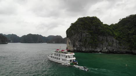 cruise ship passing through ha long bay, vietnam