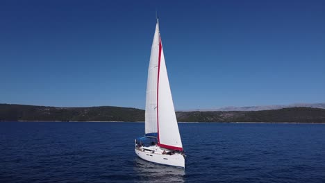 Die-Drohne-Nähert-Sich-Der-Segelyacht-Mitten-Im-Ozean-Und-Fliegt-An-Einem-Hellen-Sonnigen-Tag-In-Kroatien-Europa-Rückwärts