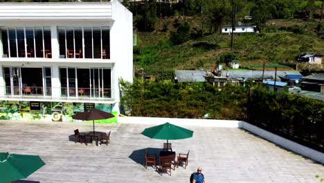 Man-Pushes-Drone-Above-Scenic-Tea-Plantation-And-Mountain-On-Sunny-Day-In-Sri-Lanka