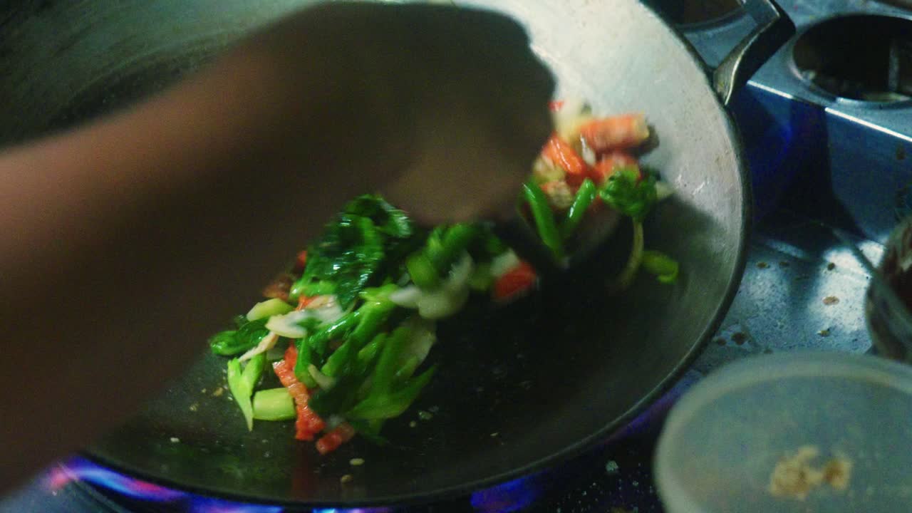 imágenes en cámara lenta de 4k de un chef tailandés cocinando comida tailandesa en la cocina de un restaurante