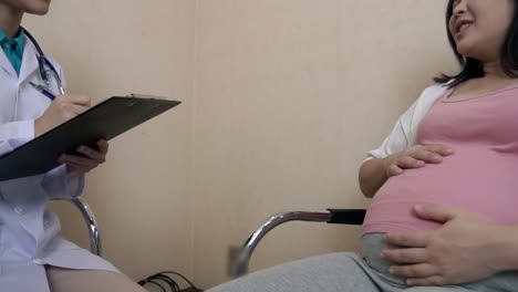 pregnant woman and gynecologist doctor at hospital