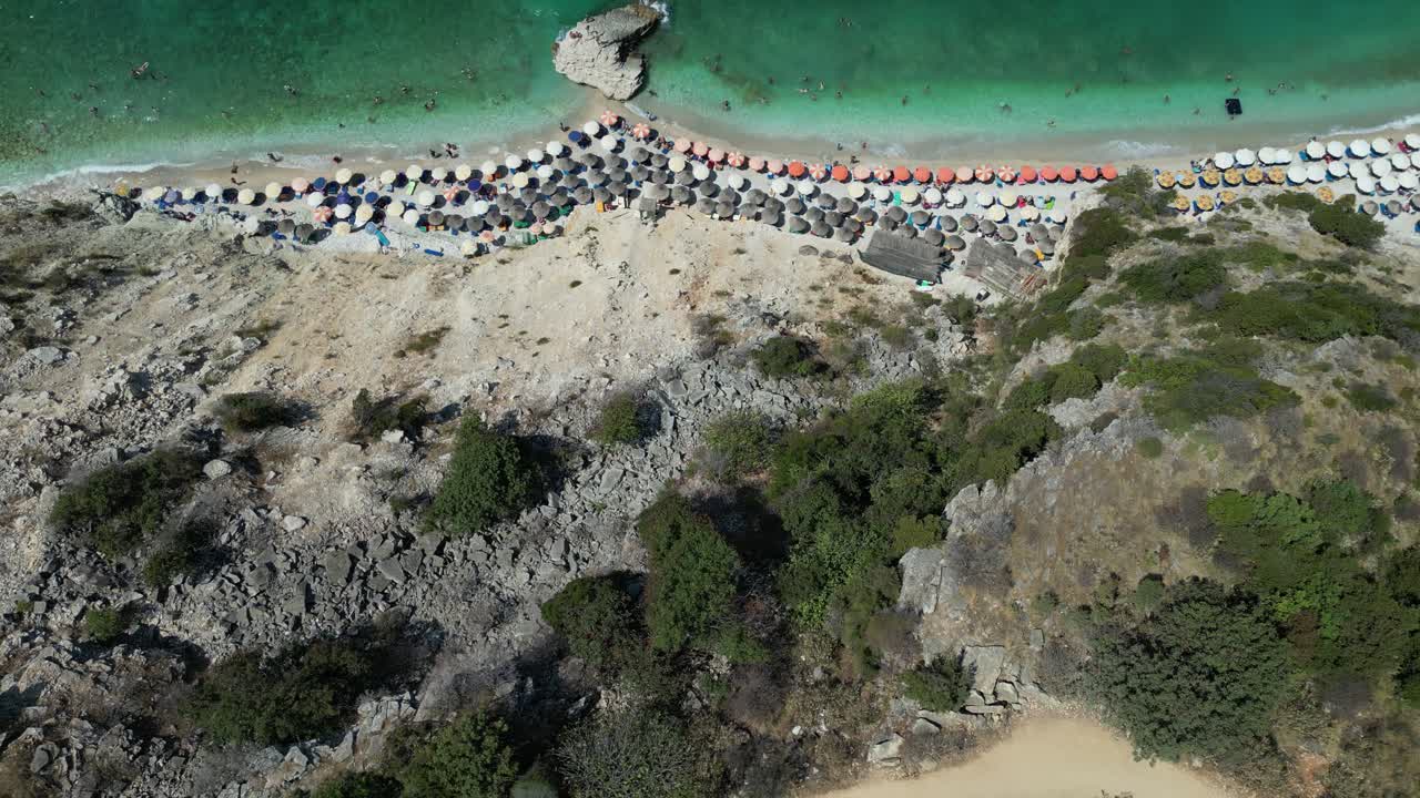 Aerial View of a Crowded Beach and a Rocky Hillside