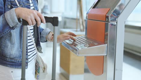 female traveller check-in at self help desk in the airport