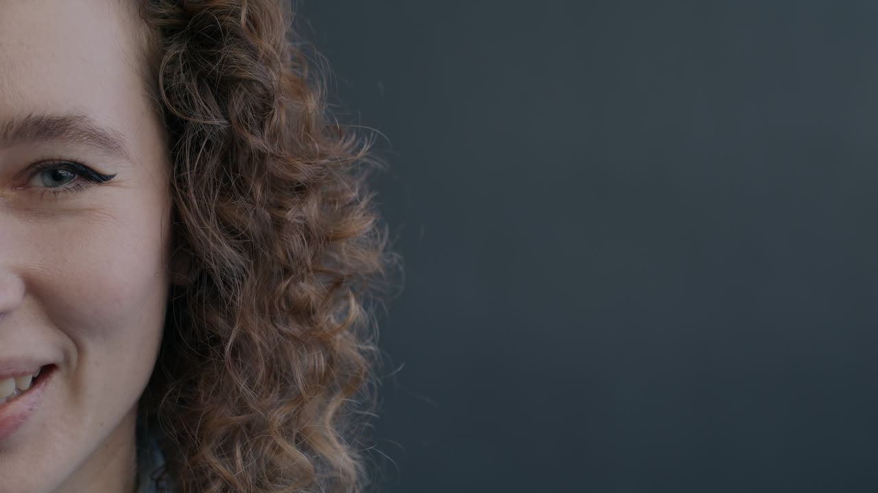 Close-up of a smiling woman with curly hair