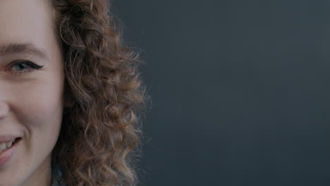 close-up of a smiling woman with curly hair