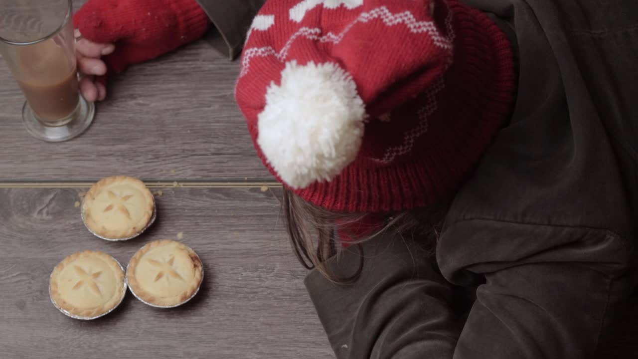 파이와 커피를 잡는 겨울 모자와 장갑을 끼고 있는 여자