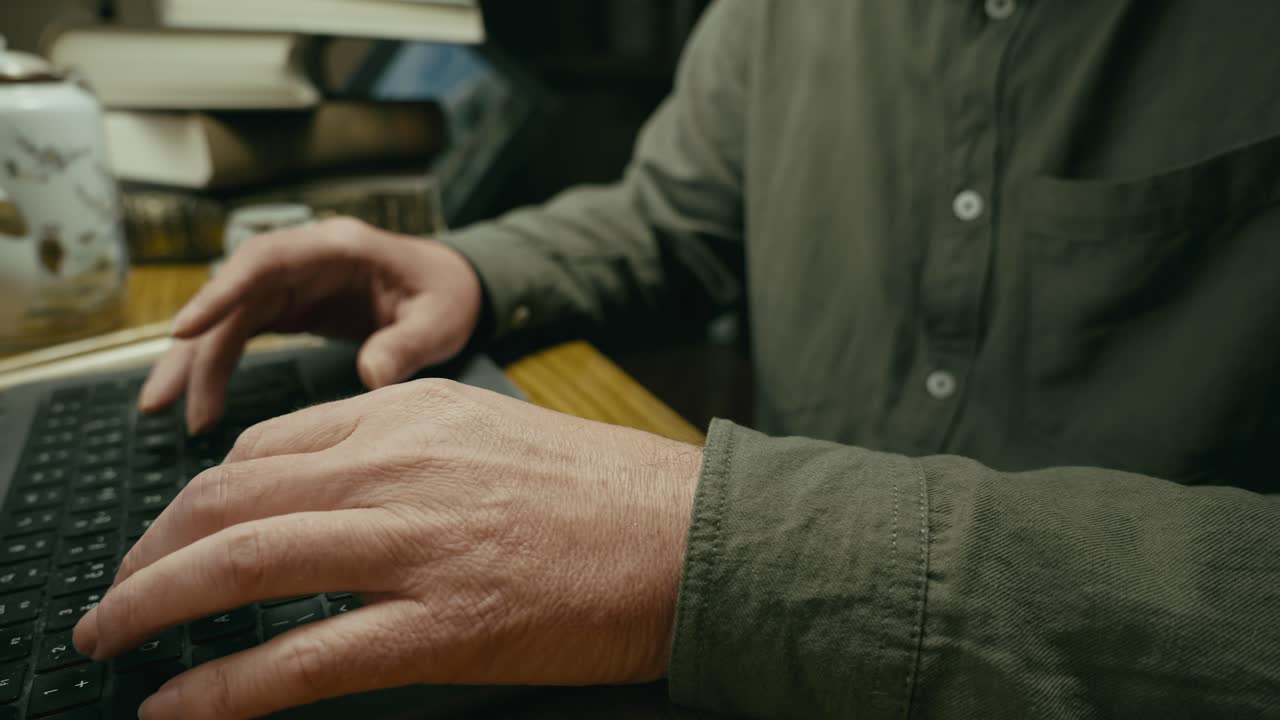 Man busy typing on laptop keyboard on home office desktop