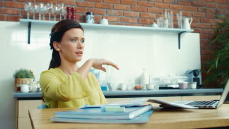 Upset-businesswoman-working-on-laptop.-Worried-girl-dropping-ruler-at-kitchen