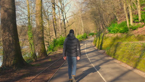 rear view of man walking in the "jardin franco-allemand" in sarrebrucken, germany