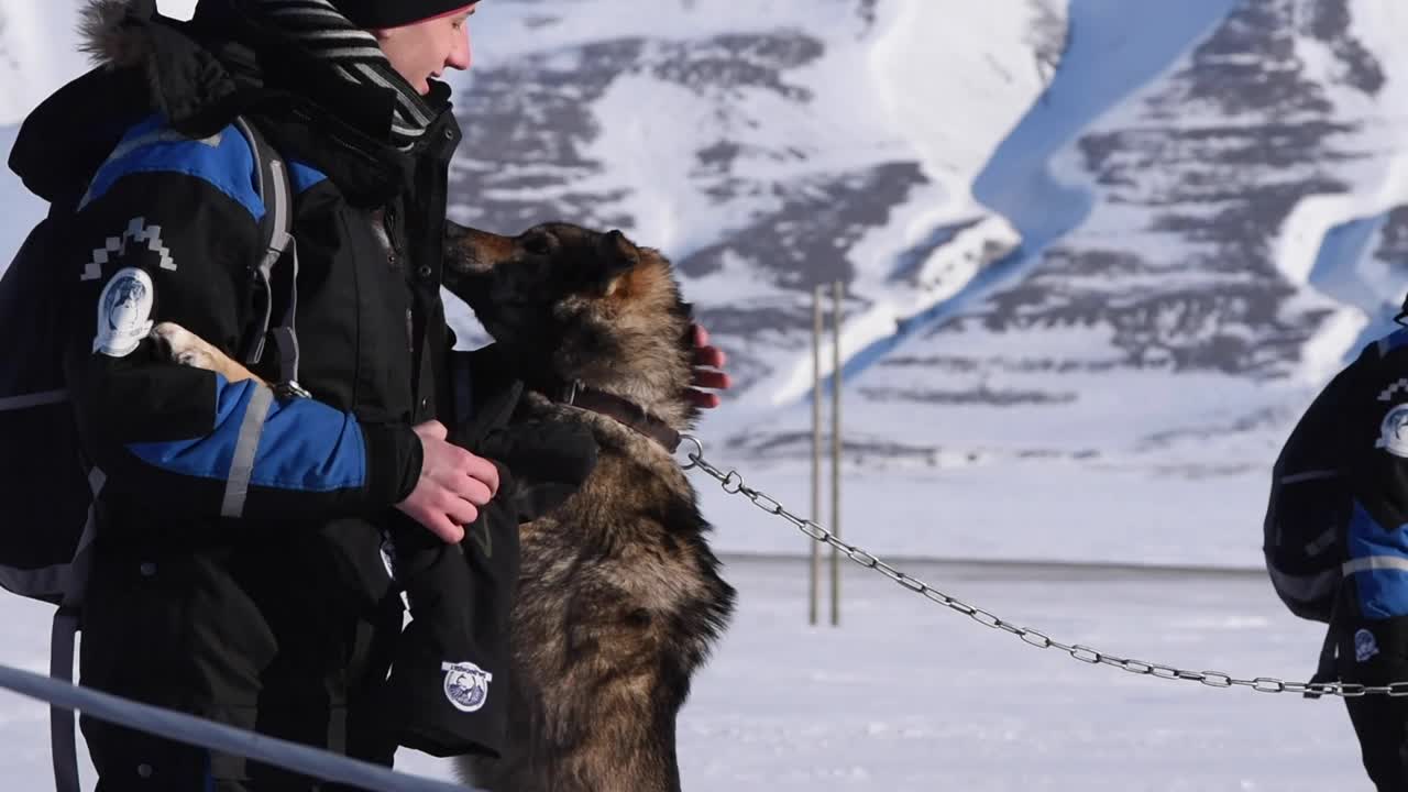 man with alaskan husky Svalbard Arctic North Pole