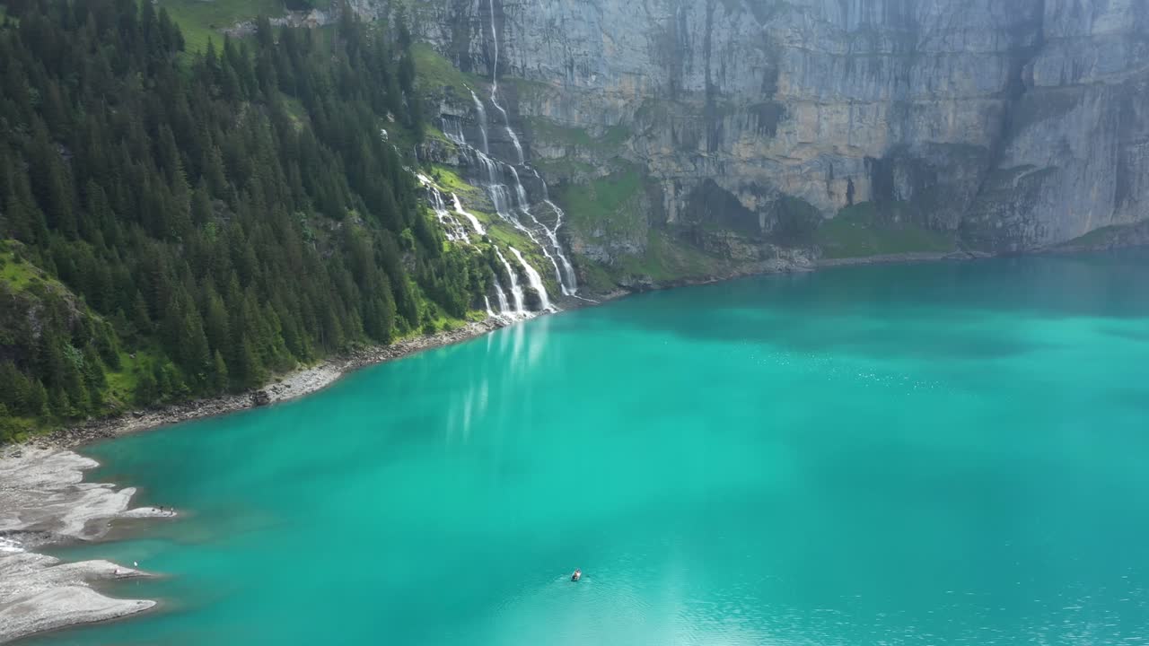 Mountain lake between the giant mountains on a cloudy and moody morning. It is captured in the Swiss Alps at Kandersteg with the DJI Mavic Pro 2.