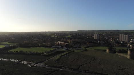 Ancient-Flint-castle-medieval-heritage-military-Welsh-ruins-aerial-view-landmark-panning-right-across-skyline