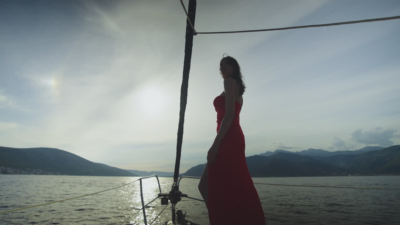 Woman in Red Dress on a Yacht at Sunset