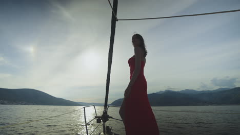 woman in red dress on a yacht at sunset