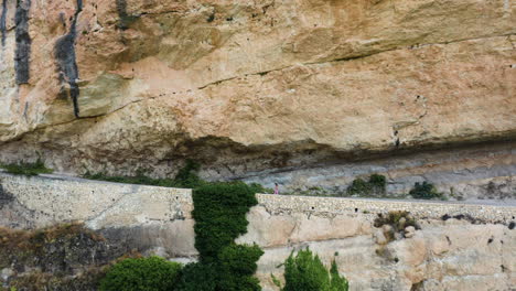 Dramatic-push-in-shot-of-young-woman-walking-along-Mirador-al-Puente-Romano-Guadalajara