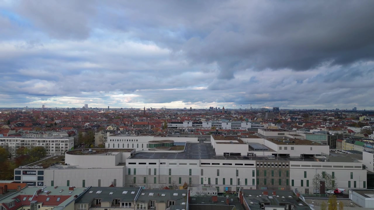 cityscape of Berlin multi-storey parking lot featuring colorful buildings and cloudy sky during a gloomy autumn day. Fabulous aerial view flight
fly reverse drone
