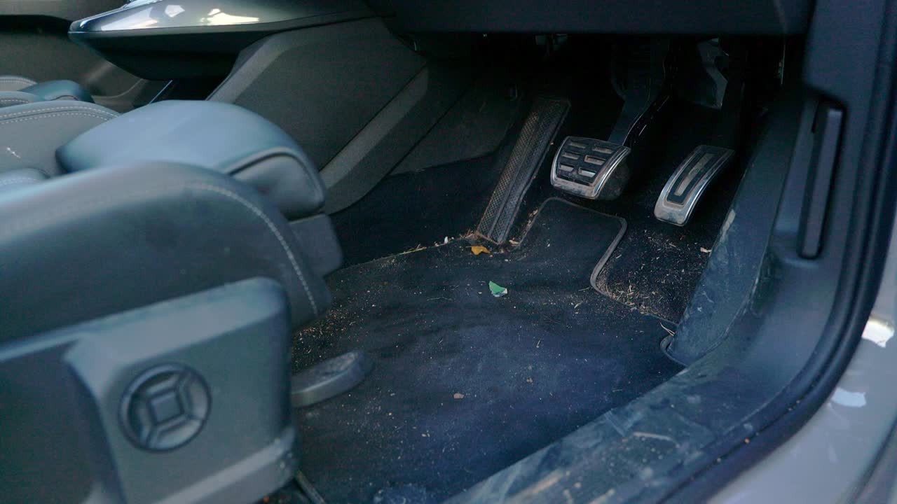 Very dirty drivers footwell - close to wide shot - dolly out