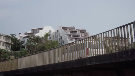 Close-up-angle-up-from-below-bridge-of-traffic-crossing-bridge