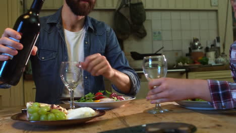 Couple-having-dinner-in-kitchen