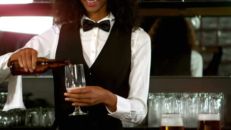 Pretty-barmaid-pouring-beer-in-a-glass