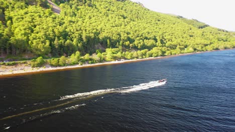 Aerial-View-of-Speedboat-Cruising-on-Loch-Ness-Waters-in-Scottish-Highlands,-Scotland