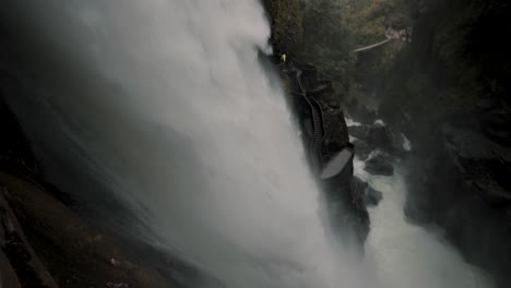 Powerful-Flow-Of-Water-Of-Pailon-Del-Diablo-Waterfall-In-Baños-De-Agua-Santa,-Ecuador---tilt-down