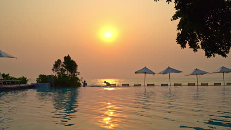 chair pool around swimming pool in hotel resort - holidays and vacations concept