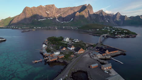 Aerial-forwarding-shot-of-Famous-wooden-fishing-houses-in-Lofoten-during-midnight-sun-season