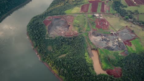 Aerial-top-down-shot-of-stone-quarry-in-Brazil-beside-Iguazu-River-during-sunny-day