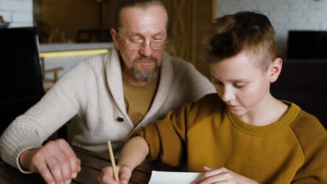 caucasian man and boy in the living room