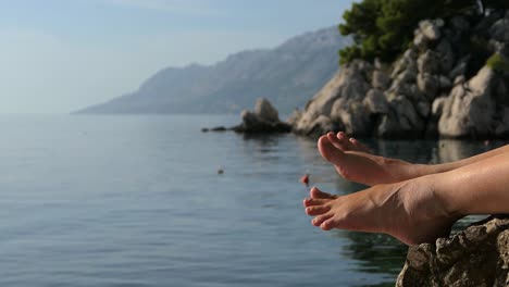 Relaxing-moment-on-vacation,-bare-feet-by-the-sea,-Mediterranean