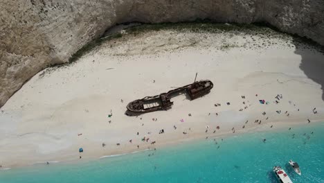 aerial view of navagio crystal water shipwreck beach in zakynthos, greece, during summer