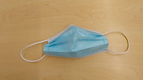 one light blue disposable medical mask, slow zoom in