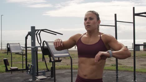 sporty caucasian woman taking deep breathing in an outdoor gym