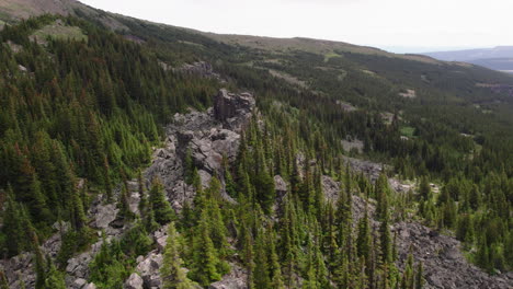 rugged rocky ridge in mountains with forest trees, british columbia