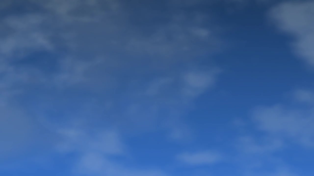Wispy white clouds drift slowly across a clear blue sky in a seamless organic loop