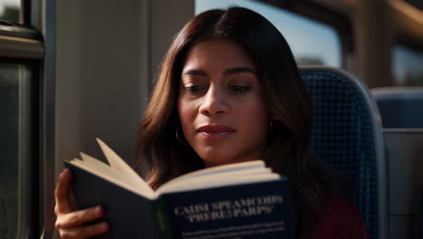 woman reading a book on public transport