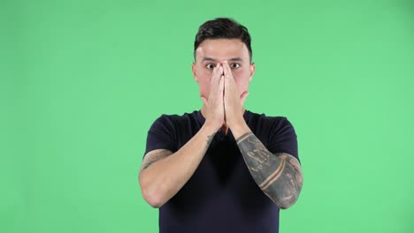 man covering mouth in surprise