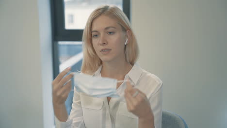 business woman put on face mask to work indoor in the office